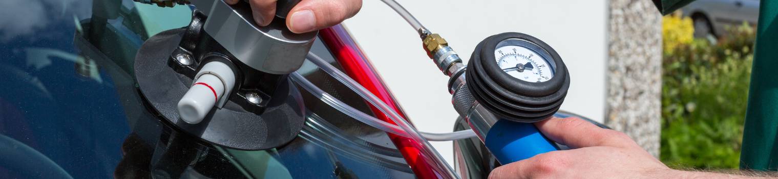 Glazier repairing windscreen after stone chipping damage